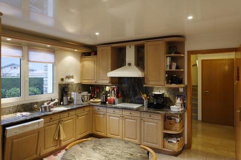 Cuisine équipée avec mobilier en chêne et plan de travail en granit